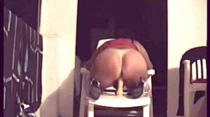 mature woman pleasures herself on the terrace
