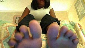 An ebony girl plays toe jerk game with instructions