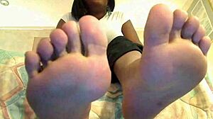 An ebony girl plays toe jerk game with instructions
