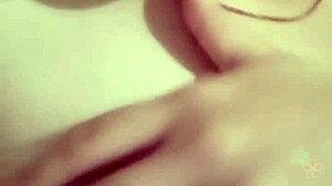 Girl masturbates showing tits and pussy