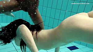 Two sexy lesbians tease underwater in the pool at beach
