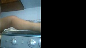 The mexican prostitute was touching herself in the kitchen while being watched voyeur style.