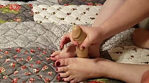 Teasing foot and hand action on slick dildo toy