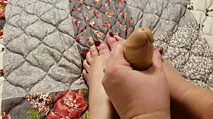 Teasing foot and hand action on slick dildo toy