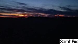 sexy tattooed hottie strips on the bed by the lake