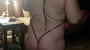 Woman Rips Off Black Dress in Striptease