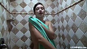 Solo teen Little Bailey fingers herself under shower water