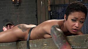 Ebony slave in wooden stock gets pussy vibed hard 😈