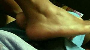 Wife gives intriguing footjob to husband in bedroom scene
