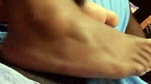 Wife gives intriguing footjob to husband in bedroom scene