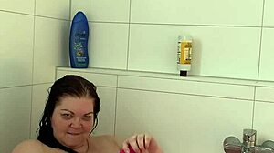 chubby milf in lingerie gives handjob in bathtub
