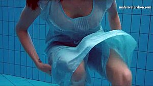 Gostosa jovem nada debaixo d'água e tira tudo na praia provocando