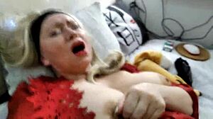 Charming mature woman fucks solo with dildo in red dress