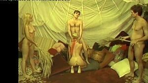 Silicone Tits Babe Uses Toys on Shaved Pussy in Retro Scene.