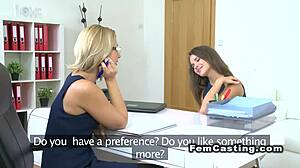 blonde agent fingers brunette’s pussy from behind at work! 🔥