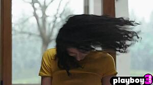 Petite curly teen model Lucy M poses in the kitchen.