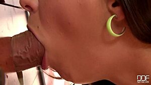 Teen gives sloppy blowjob through office gloryhole