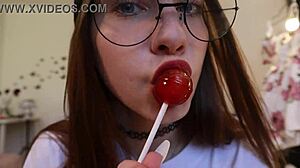 nothing unusual, just a girl sucking on a lollipop while clothed