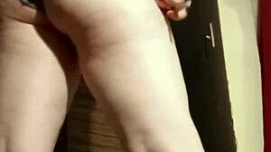 Busty camgirl in grey gently fingers her ass