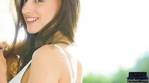 Watch this brunette babe striptease outdoors