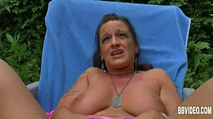 This tattooed European MILF with big tits is casually masturbating outdoors in Germany