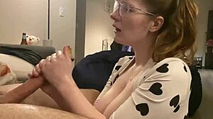 the huge cock sprays cum all over the huge tits in the bodysuit after a handjob