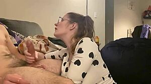 the huge cock sprays cum all over the huge tits in the bodysuit after a handjob