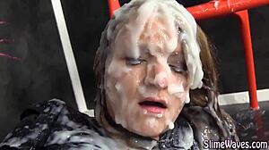 European Glamour Babe Rubs Cunt At Gloryhole, Receives Messy Bukkake Cumshot In Heels