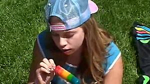 Teen Little April rubs clit outdoors while sucking popsicle