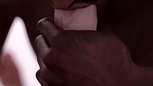 Black guy eagerly sucks huge white cock in intense blowjob.