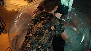 Two sweet guys share an inflatable chair, relaxing together in a casual setting