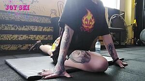 alternative girl does stretching exercises at the gym
