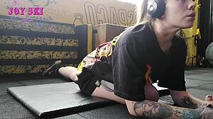 alternative girl does stretching exercises at the gym