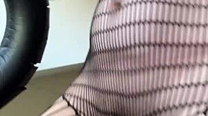 Brunette in fishnets starts a sexy fetish workout with athletic moves. Her small tits bounce during intense action.