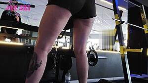 alternative girl does stretching exercises at the gym