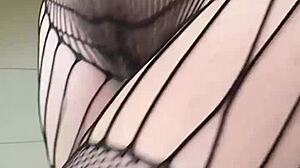 Brunette in fishnets starts a sexy fetish workout with athletic moves. Her small tits bounce during intense action.