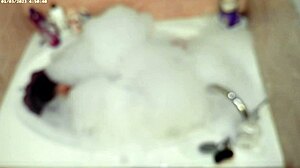 A young asian amateur enjoys a relaxing bubble bath in the bathroom, showcasing his feet and naked body.