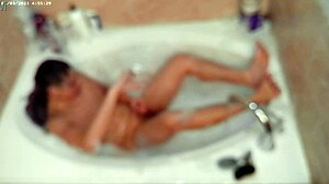 A young asian amateur enjoys a relaxing bubble bath in the bathroom, showcasing his feet and naked body.