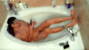 A young asian amateur enjoys a relaxing bubble bath in the bathroom, showcasing his feet and naked body.