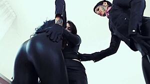 Detailed leather-clad lesbian threesome sex at the office with group action