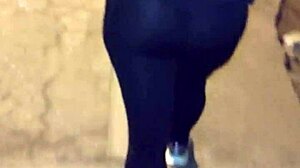 Mature woman with huge ass in transparent leggings walks the street