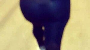 Mature woman with huge ass in transparent leggings walks the street