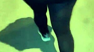 Mature woman with huge ass in transparent leggings walks the street