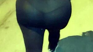 Mature woman with huge ass in transparent leggings walks the street