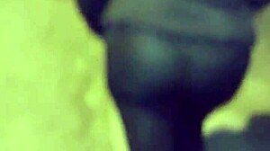 Mature woman with huge ass in transparent leggings walks the street