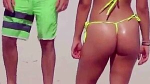 Awesome young girl in micro bikini on the beach with relatives