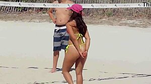 Awesome young girl in micro bikini on the beach with relatives
