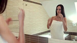 Brunette Eveline fingers pussy in bathroom
