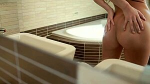 Brunette Eveline fingers pussy in bathroom