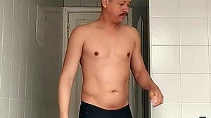 i'm the sexy guy shaving in black beach shorts